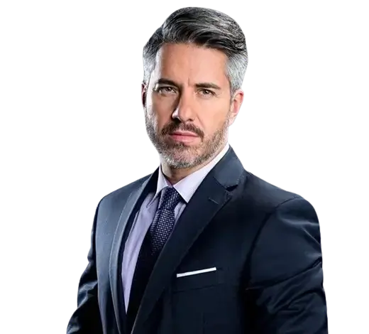 Professional head-and-shoulders portrait of a man in a navy suit and purple tie, looking at the camera.