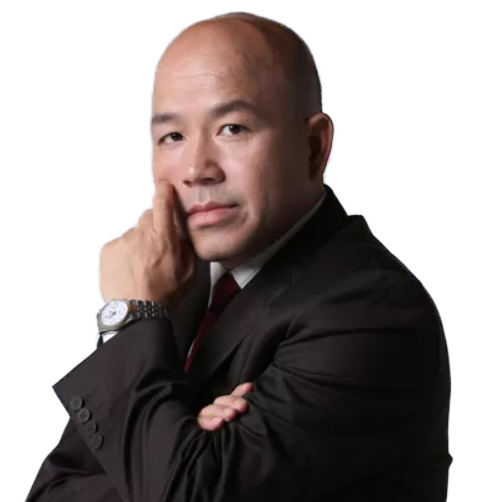 Businessman in a black suit posing with his hand on his chin, looking at the camera, wearing a silver wristwatch