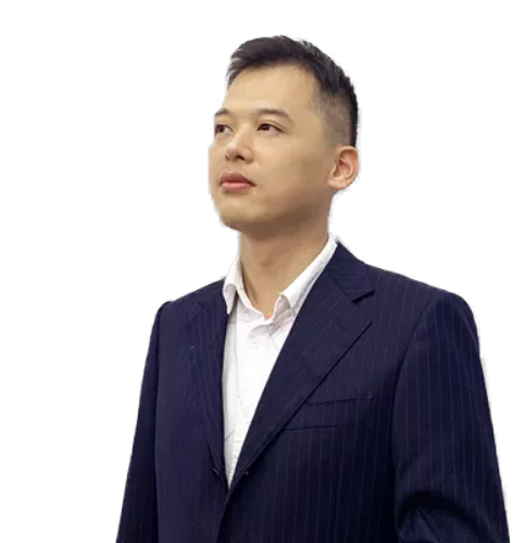 Professional portrait of a man in a navy pinstripe suit looking slightly upward to the left against a gray background.