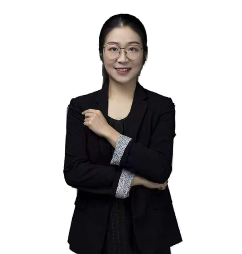 Professional woman wearing a black blazer and glasses, arms crossed, smiling confidently.